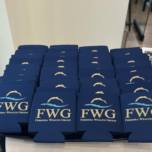 Stack of navy custom koozies printed with a wealth management firm's logo on a conference table